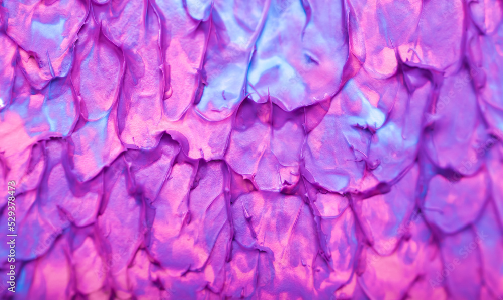 Obraz premium Beautiful abstract background with spots of blue, pink, green, yellow and purple paint. Oil paint, flowing down the canvas, shimmers with galagrophic paints with neon illumination.