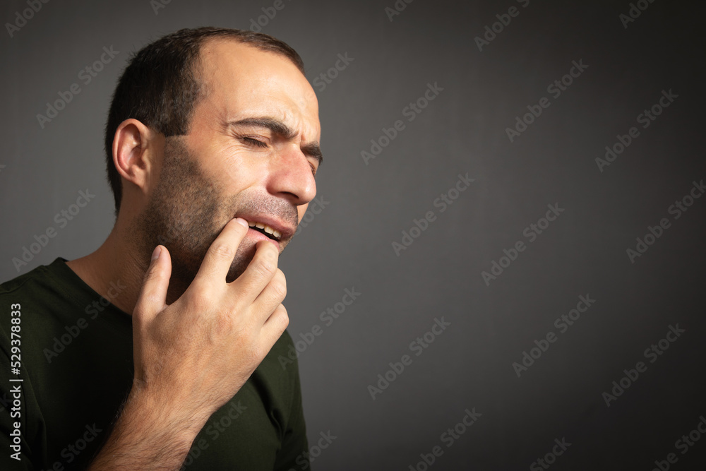 Caucasian man suffering from tooth pain. Caucasian man suffering from tooth pain.
