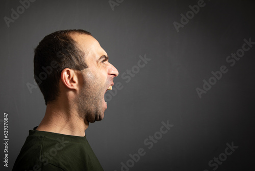 Angry caucasian young man shouting.