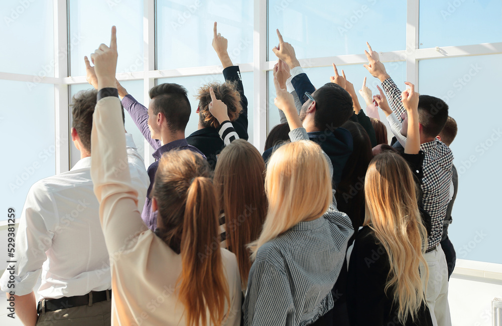 Obraz premium group of diverse young business people pointing in one direction
