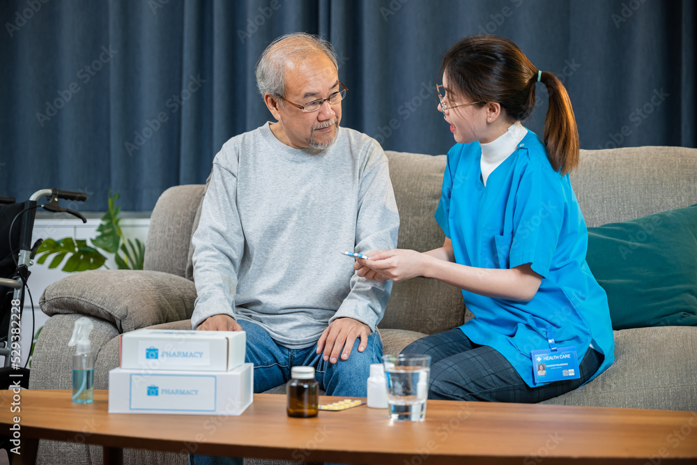 Obraz premium Woman nurse caregiver showing prescription drug to senior man at nursing home, healthcare support, Asian doctor with physician visit senior male patient consult medicine dosage at house in living room