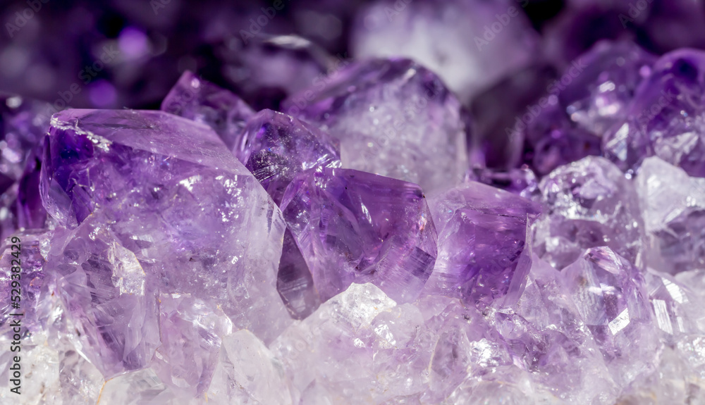 Amethyst pink crystals. Gems. Mineral crystals in the natural environment.  Texture of precious and semiprecious stones. Seamless background with copy  space colored shiny surface of precious stones. Stock Photo