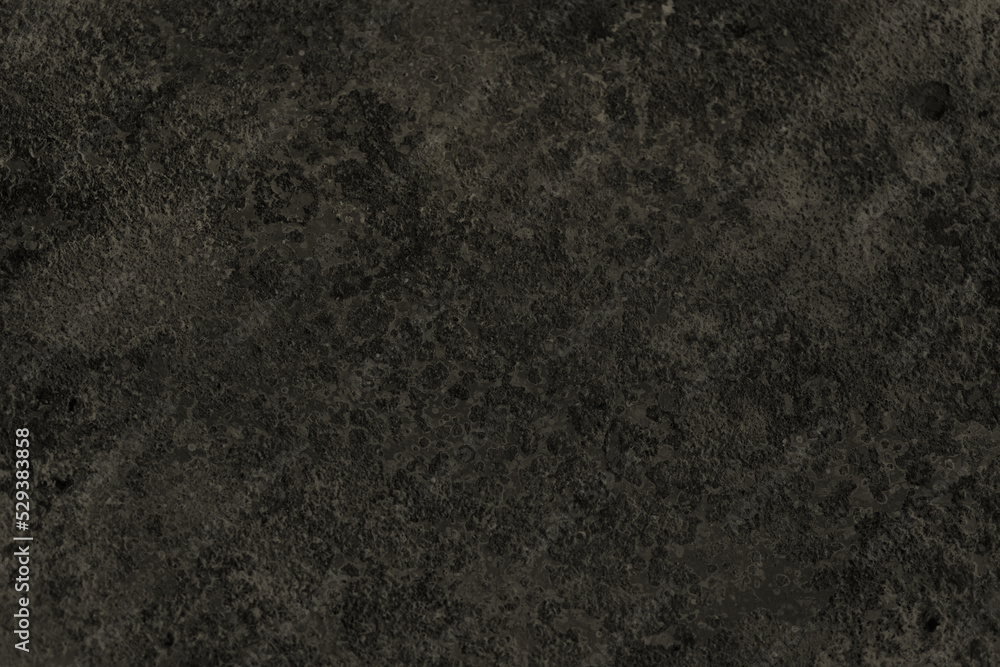 Fototapeta premium Dark background of decorative plaster with abstract spots. Unusual black or gray wall texture with beautiful patterns, creative surface background. Finishing coating for building cladding.