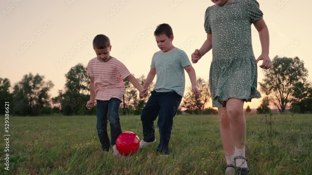 Children son daughter play football on lawn. Happy family. Active