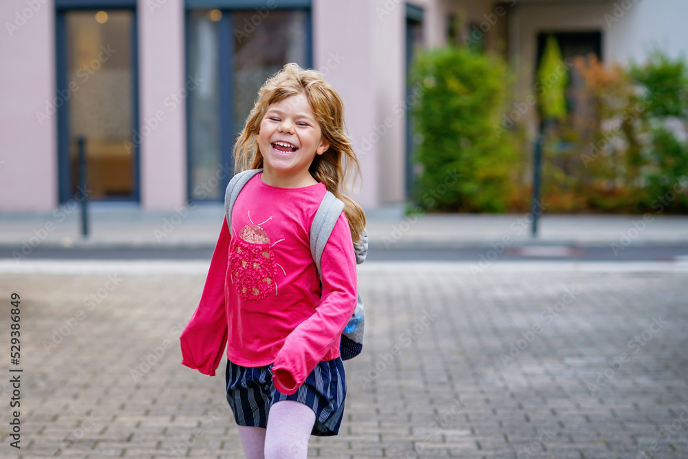 Cute little preschool girl o the way to school Healthy happy child walking to nursery school and kindergarten. Smiling child with backpack on the city street, outdoors. Back to school.