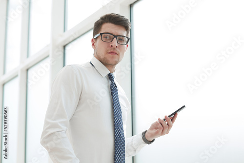 businessman use phone and smile in the office