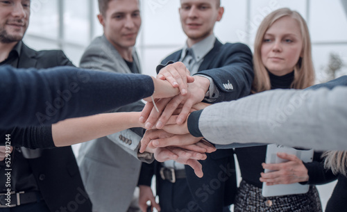 close up. group of young employees standing in a circle © ASDF