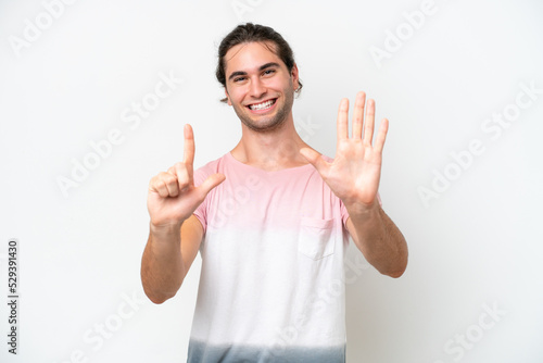 Caucasian handsome man isolated on white background counting seven with fingers