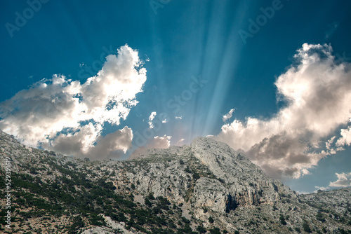landscape with clouds and sunlight over the mountains