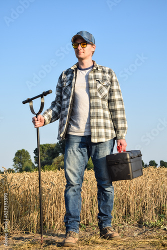 Obraz na plátně Agronomist preparing to take sample with soil probe sampler at agricultural field at sunrise
