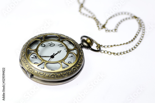 An old pocket watch on a white background
