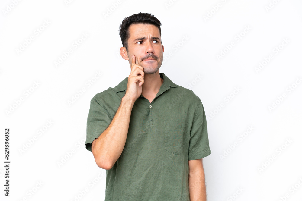 Young handsome man over isolated white background having doubts and thinking Young handsome man over isolated white background having doubts and thinking