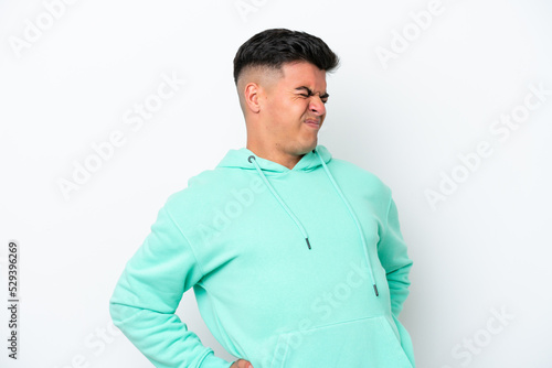 Young caucasian handsome man isolated on white background suffering from backache for having made an effort © luismolinero