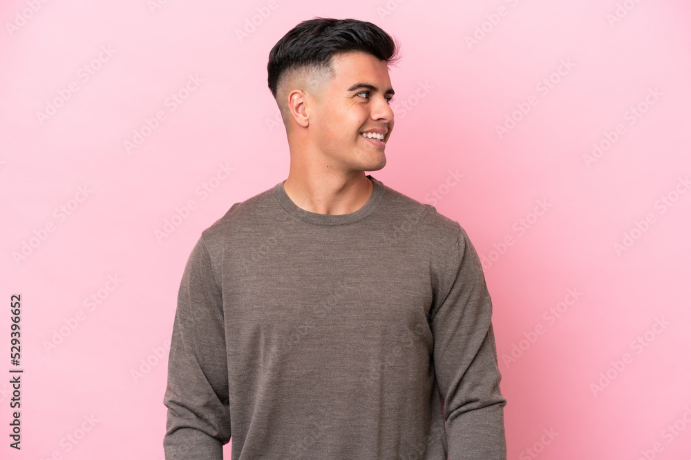 Young caucasian handsome man isolated on pink background looking side Young caucasian handsome man isolated on pink background looking side