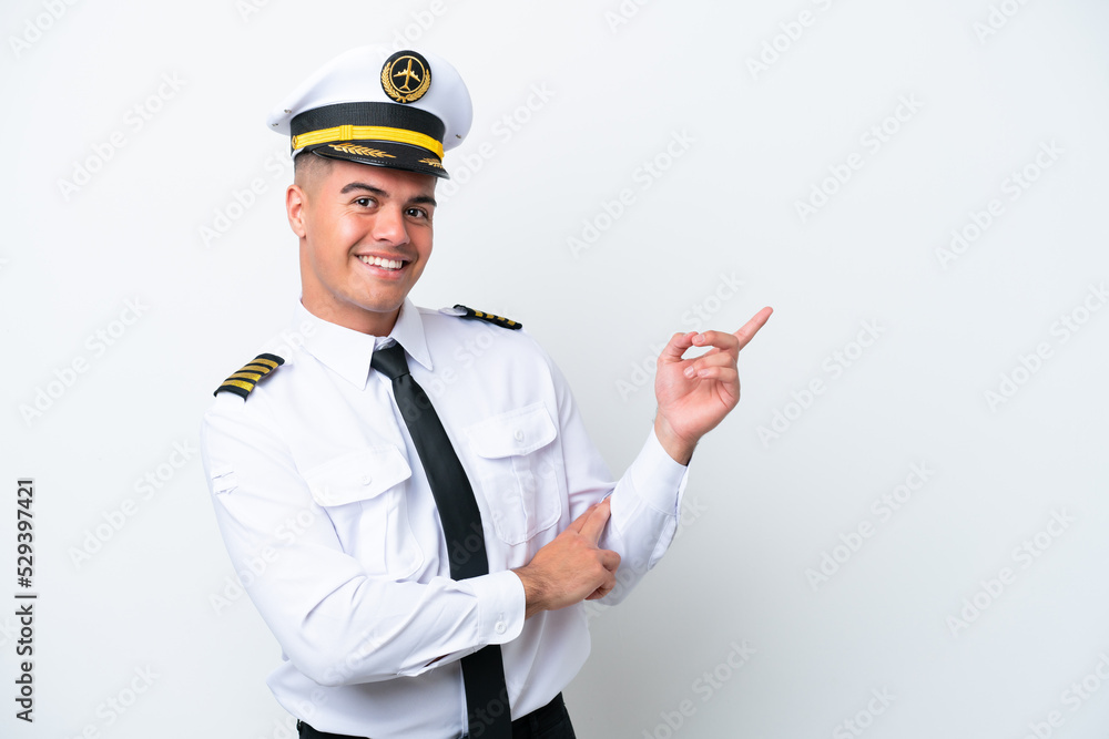 Airplane pilot caucasian man isolated on white background pointing finger to the side Airplane pilot caucasian man isolated on white background pointing finger to the side