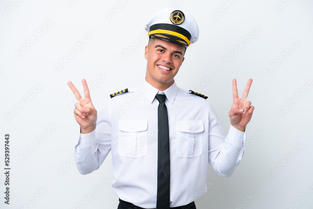 Airplane pilot caucasian man isolated on white background showing victory sign with both hands Airplane pilot caucasian man isolated on white background showing victory sign with both hands