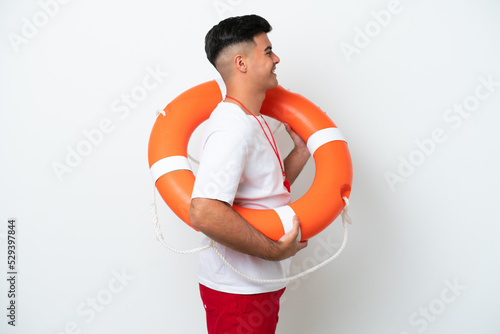 Young handsome man isolated on white background with lifeguard equipment and with happy expression