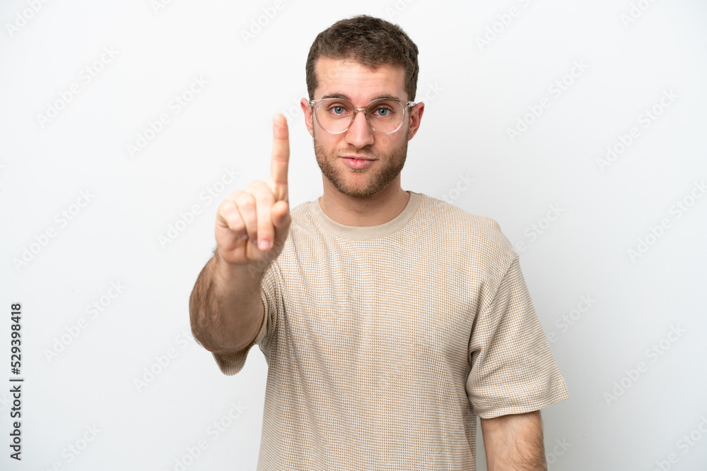 Young caucasian man isolated on white background counting one with serious expression Young caucasian man isolated on white background counting one with serious expression