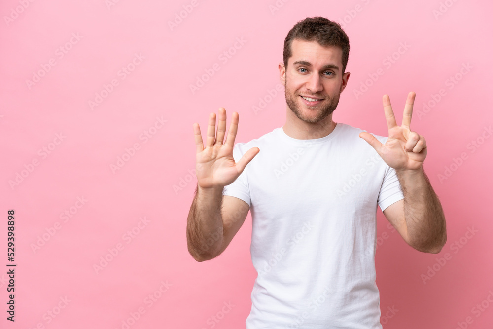 Young caucasian man isolated on pink background counting eight with fingers Young caucasian man isolated on pink background counting eight with fingers