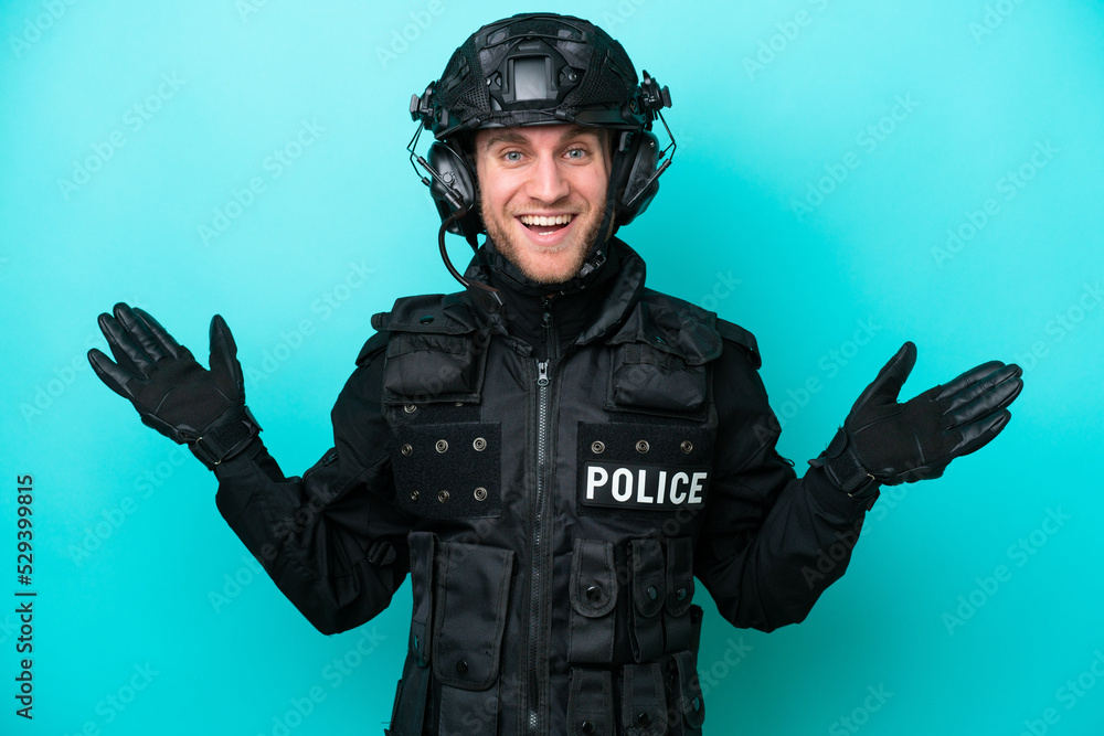 SWAT caucasian man isolated on blue background with shocked facial expression SWAT caucasian man isolated on blue background with shocked facial expression