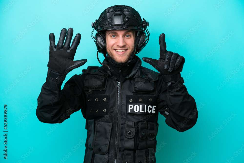 SWAT caucasian man isolated on blue background counting seven with fingers SWAT caucasian man isolated on blue background counting seven with fingers