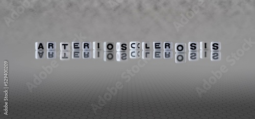 arteriosclerosis word or concept represented by black and white letter cubes on a grey horizon background stretching to infinity