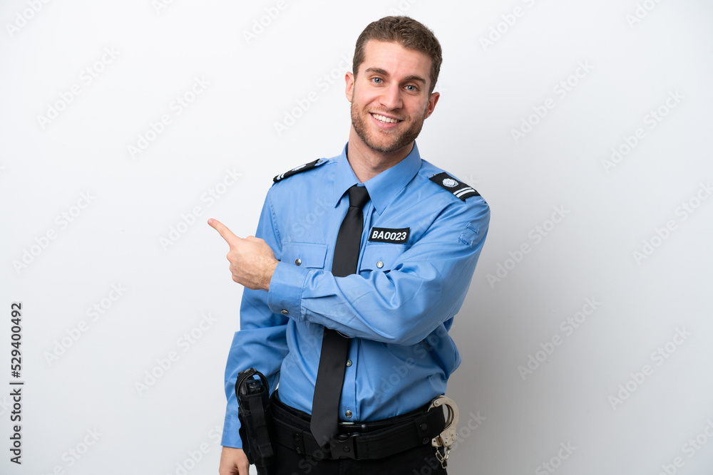 Young police caucasian man isolated on white background pointing back