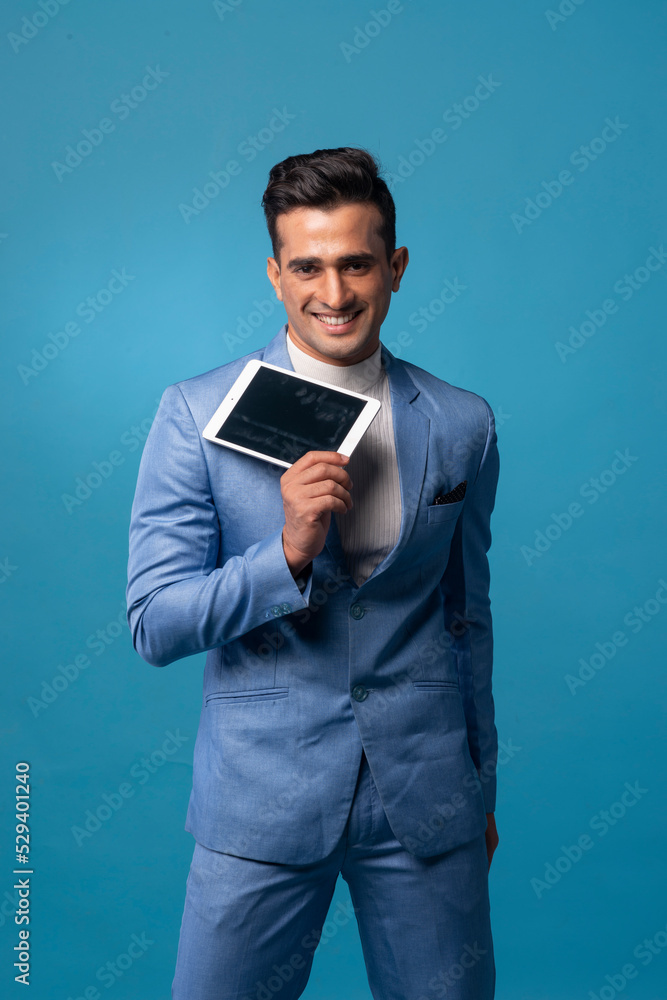 Young handsome man wearing business suit with tablet computer Young handsome man wearing business suit with tablet computer