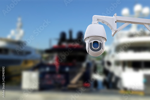 security CCTV camera or surveillance system with Marina on blurry background.