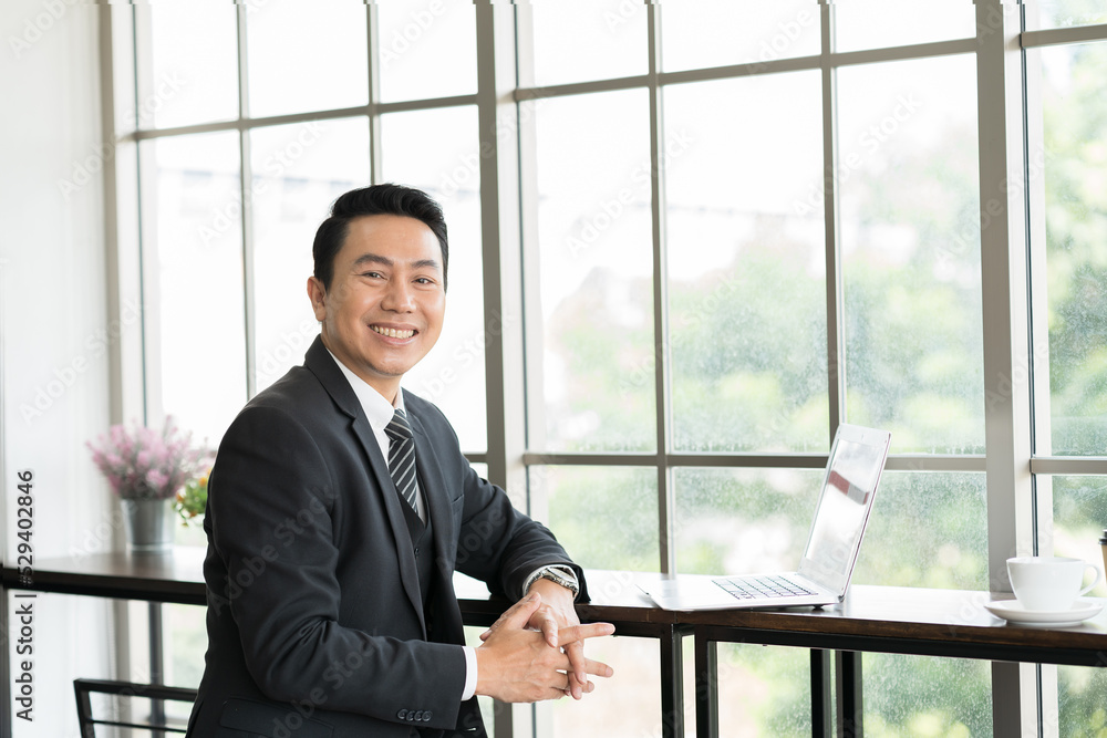 Asian business man wear suit at the office. Smiling Asian business man working in the office