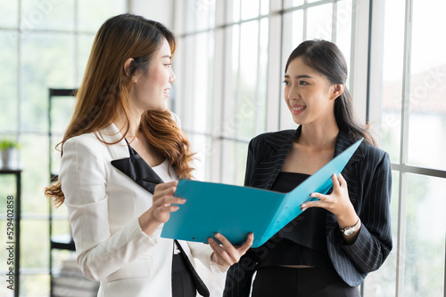 Two Asian women working and discuss at the office. Brainstorming and share ideas concept