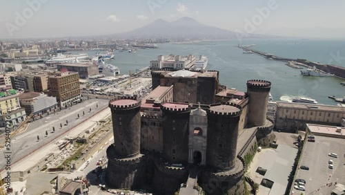Impressive medieval fortress Castel Nuovo in Naples, Italy; drone arc photo