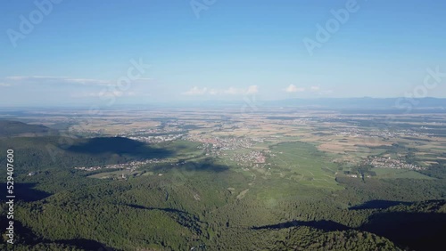 Aerial drone lateral traveling movement to the right, reveals the mountain of Vieil Armand, the Hartmannswillerkopf and the plain below with the Alsace villages Berrwiller, Soultz-Haut-Rhin, Wuenheim photo