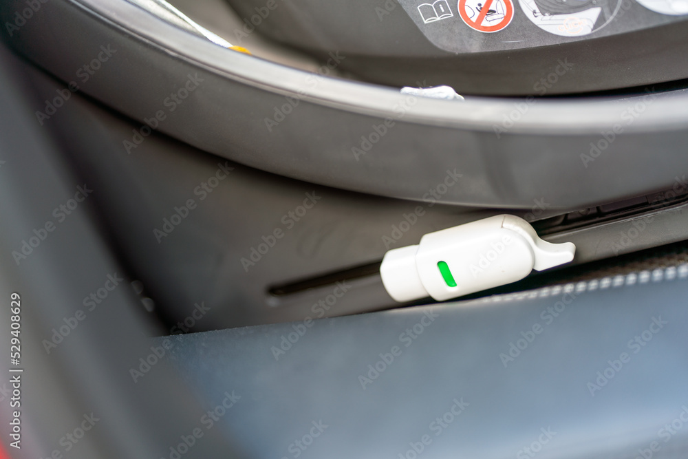 Obraz premium Isofix connection standard to fasten childrens carseat to car interior. Safety and transport concept.