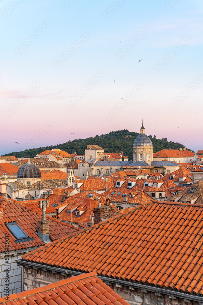 City view of Dubrovnik, Croatia, buildings with orange roofs in old town during sunset