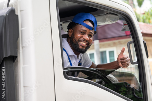 Happy African American driving delivery men in truck	