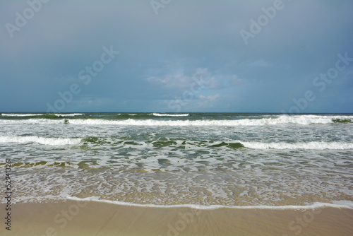 Fototapeta Naklejka Na Ścianę i Meble -  Beautiful coast of the Baltic Sea in Poland. Endless sandy beach, sea water waves.