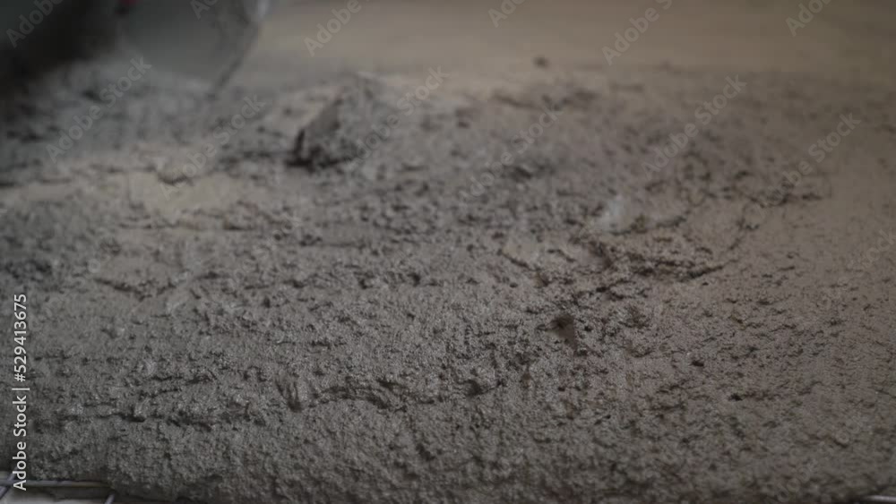 Master leveling fresh concrete on the floor. The builder lays the mortar on the floor. Master leveling fresh concrete on the floor. The builder lays the mortar on the floor.