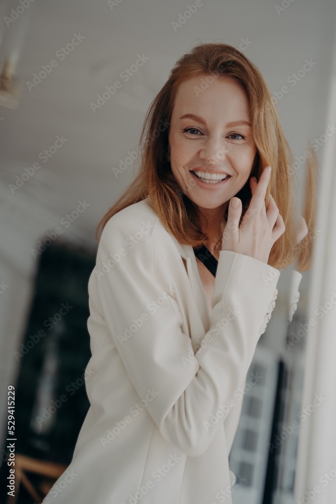 Mirror reflection of happy mid adult woman picking up evening look. Lady is going to go to party. Mirror reflection of happy mid adult woman picking up evening look. Lady is going to go to party.