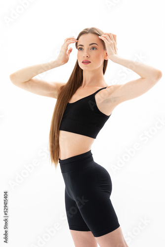 Slim sporty fitness young woman in black sportswear posing © Andrei Pozharskiy