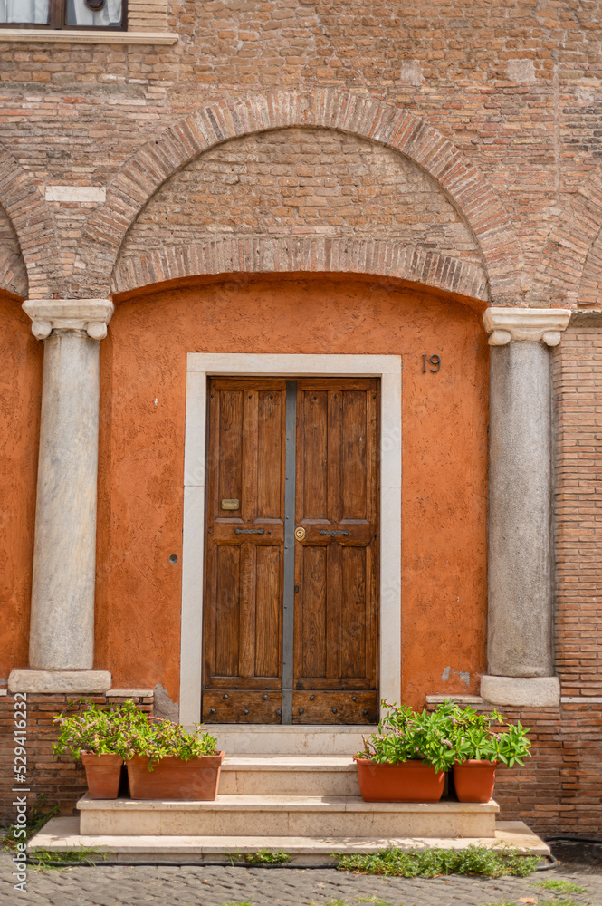 Beautiful carved wooden antique vintage doors on the street in trastevere area