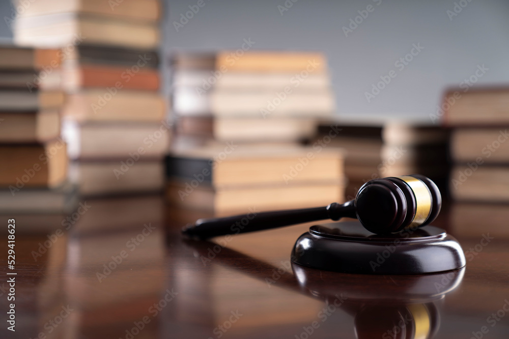 Law theme - judge office. Gavel and legal books on the judge desk. Law theme - judge office. Gavel and legal books on the judge desk.