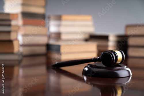 Law theme - judge office. Gavel and legal books on the judge desk. 