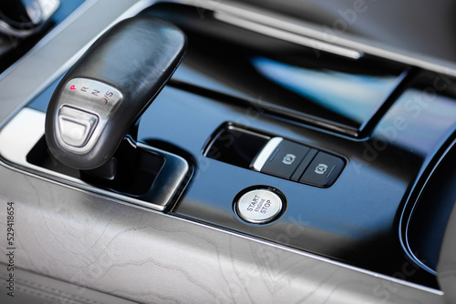 Gear shift lever and car start button. © kucheruk