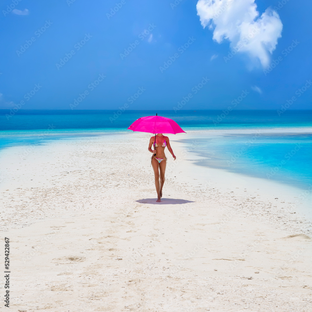 Sexy bikini body woman on paradise tropical beach having fun on Maldives. Beautiful female model is holding pink umbrella and is walking on the sandy beach. Sexy girl in bikini on a paradise beach. Sexy bikini body woman on paradise tropical beach having fun on Maldives. Beautiful female model is holding pink umbrella and is walking on the sandy beach. Sexy girl in bikini on a paradise beach.