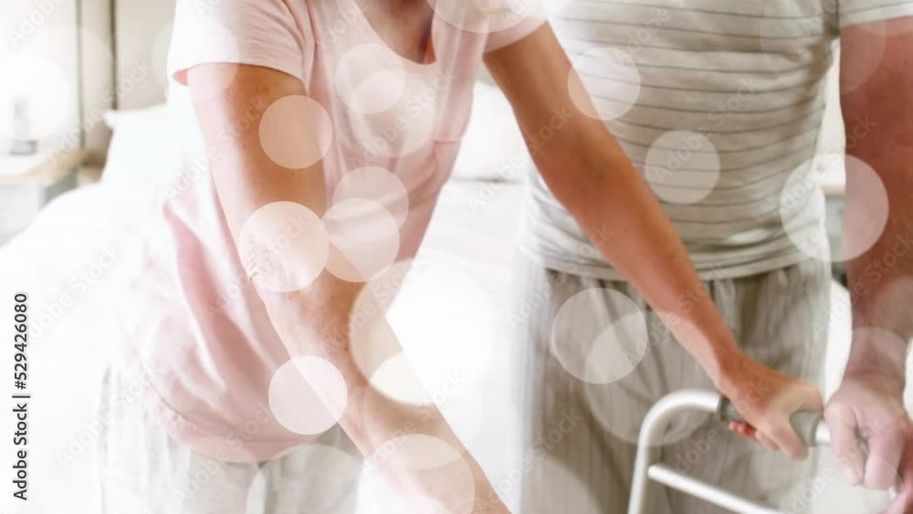 Animation of spots over disabled caucasian woman with husband Animation of spots over disabled caucasian woman with husband