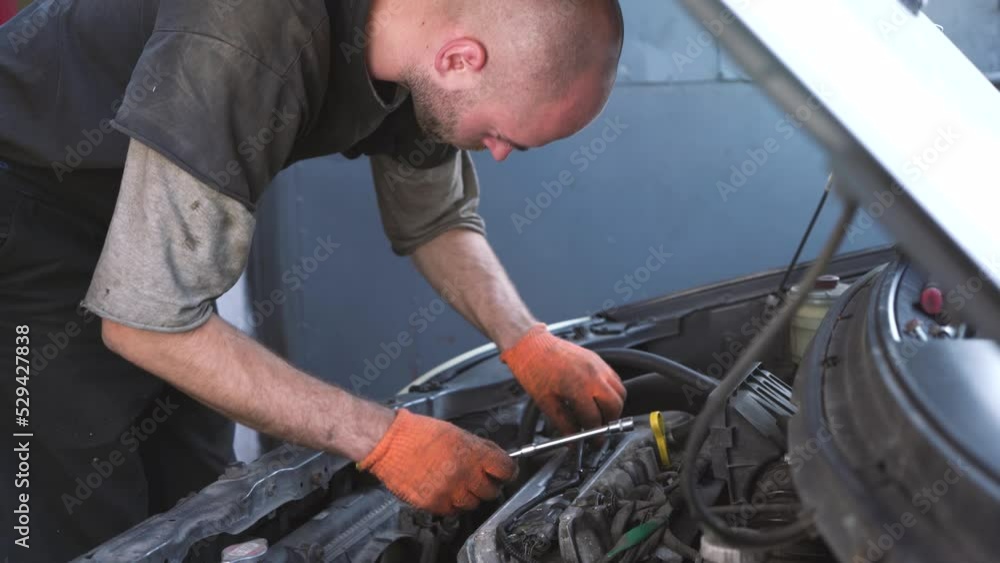 auto mechanic repairs sedan auto. close-up auto mechanic repairs sedan auto. close-up