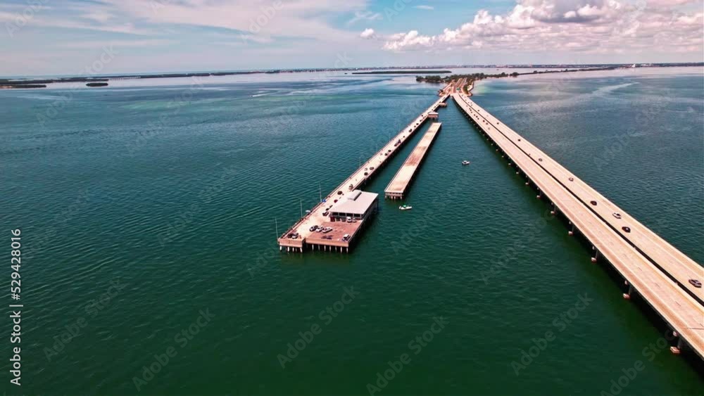 Sunshine Skyway Fishing Pier Next To Bob Graham Sunshine Skyway Bridge On Tampa Bay In Florida. aerial
