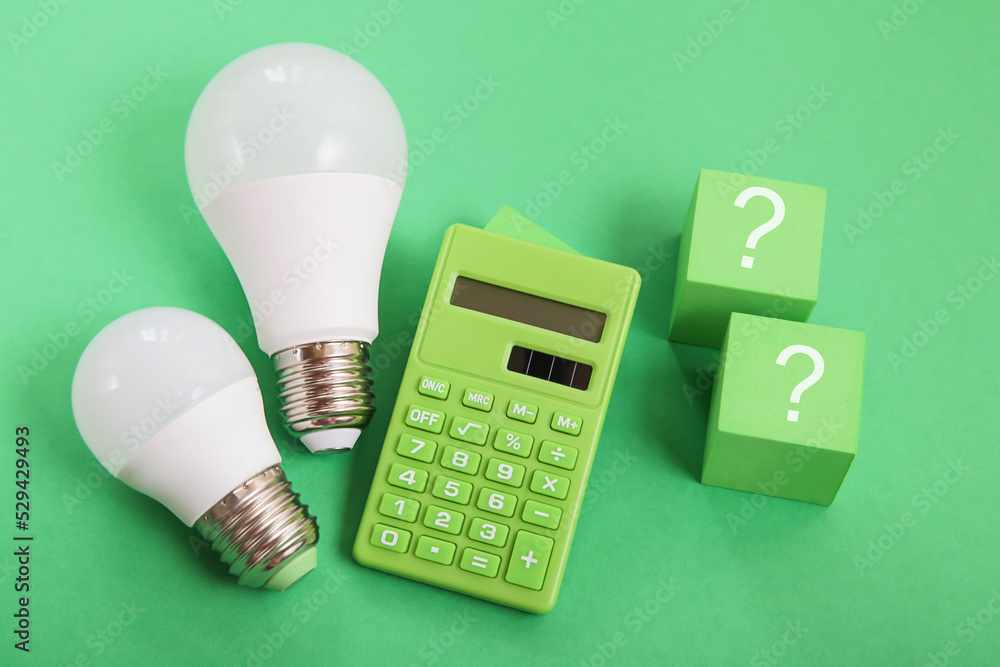 Light bulb, Green calculator, question mark on green background. Concept of  competition for Green Energy market Stock Photo | Adobe Stock