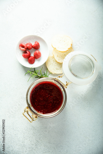Raspberry jam or sauce with fresh rosemary